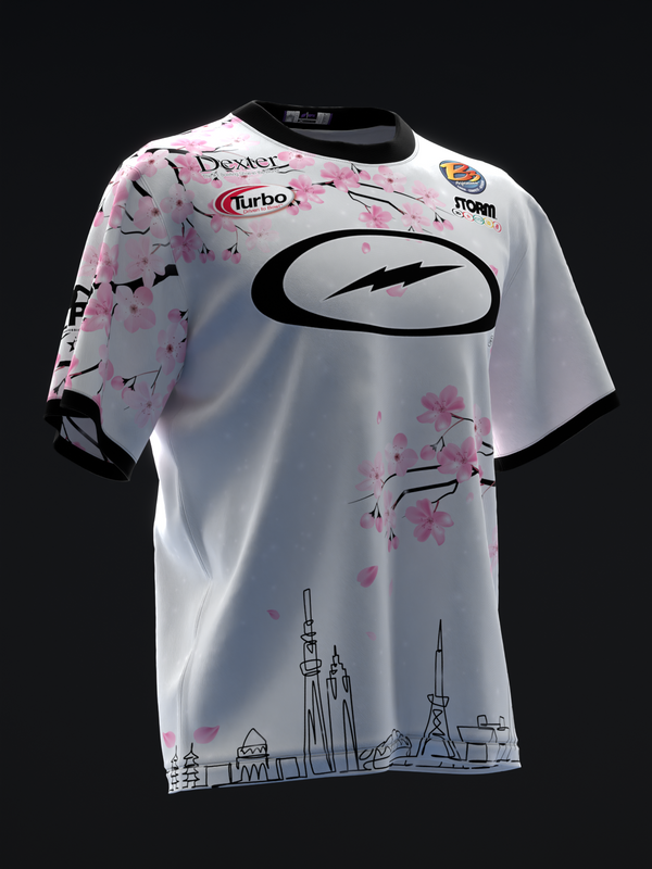 White bowling jersey with pink cherry blossoms, black logo, and cityscape hem design