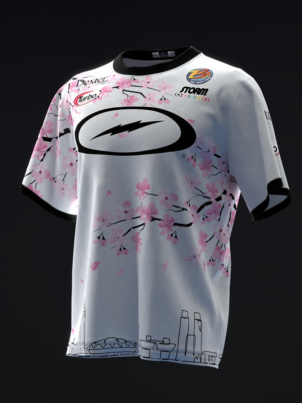 White bowling jersey with pink cherry blossom pattern and black oval logo