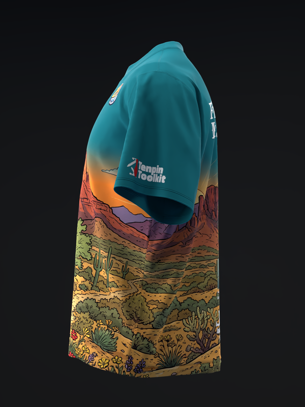 Teal bowling jersey with desert landscape graphic featuring canyon and vegetation design