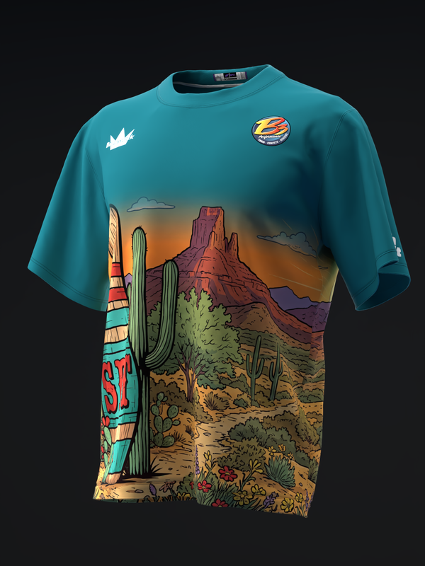 Teal bowling jersey with desert landscape graphic featuring cacti and rock formations