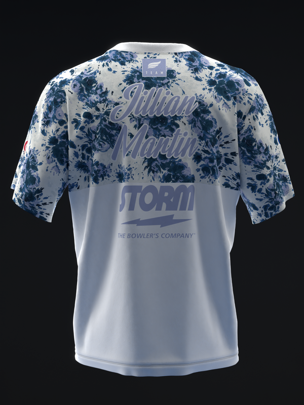 Back view of white bowling jersey with blue floral pattern on sleeves and Storm logo