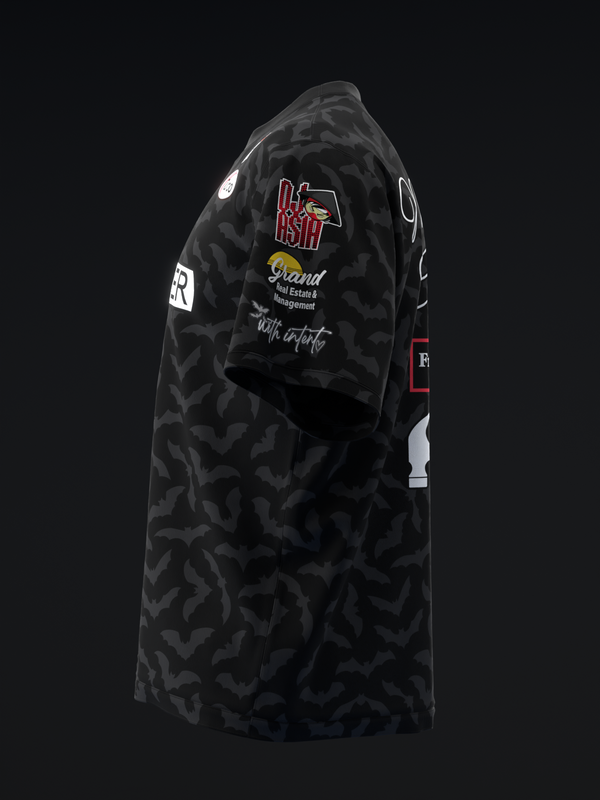 Black bowling jersey with bat pattern and red BST logo on chest, side view