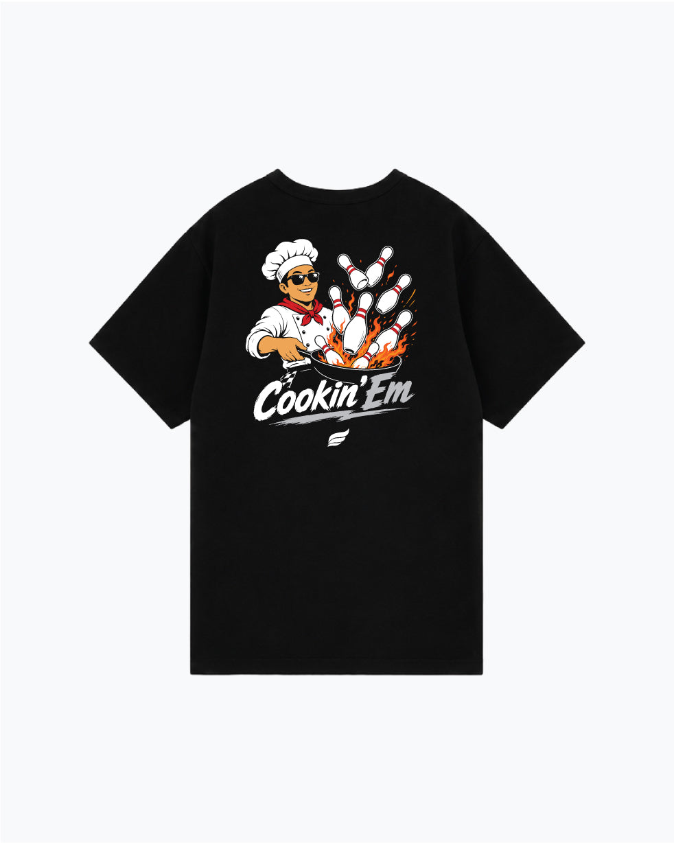 Black t-shirt with chef character and bowling pins graphic reading Cookin Em