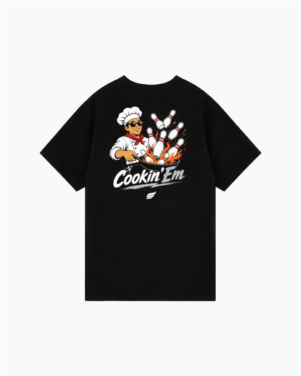 Black t-shirt with chef character and bowling pins graphic reading Cookin Em