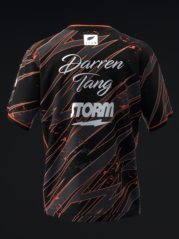 Black bowling jersey with orange lightning bolt pattern and white text graphic back view