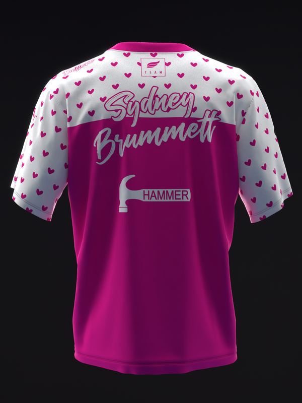 Back view of magenta bowling jersey with white heart pattern sleeves and text graphics